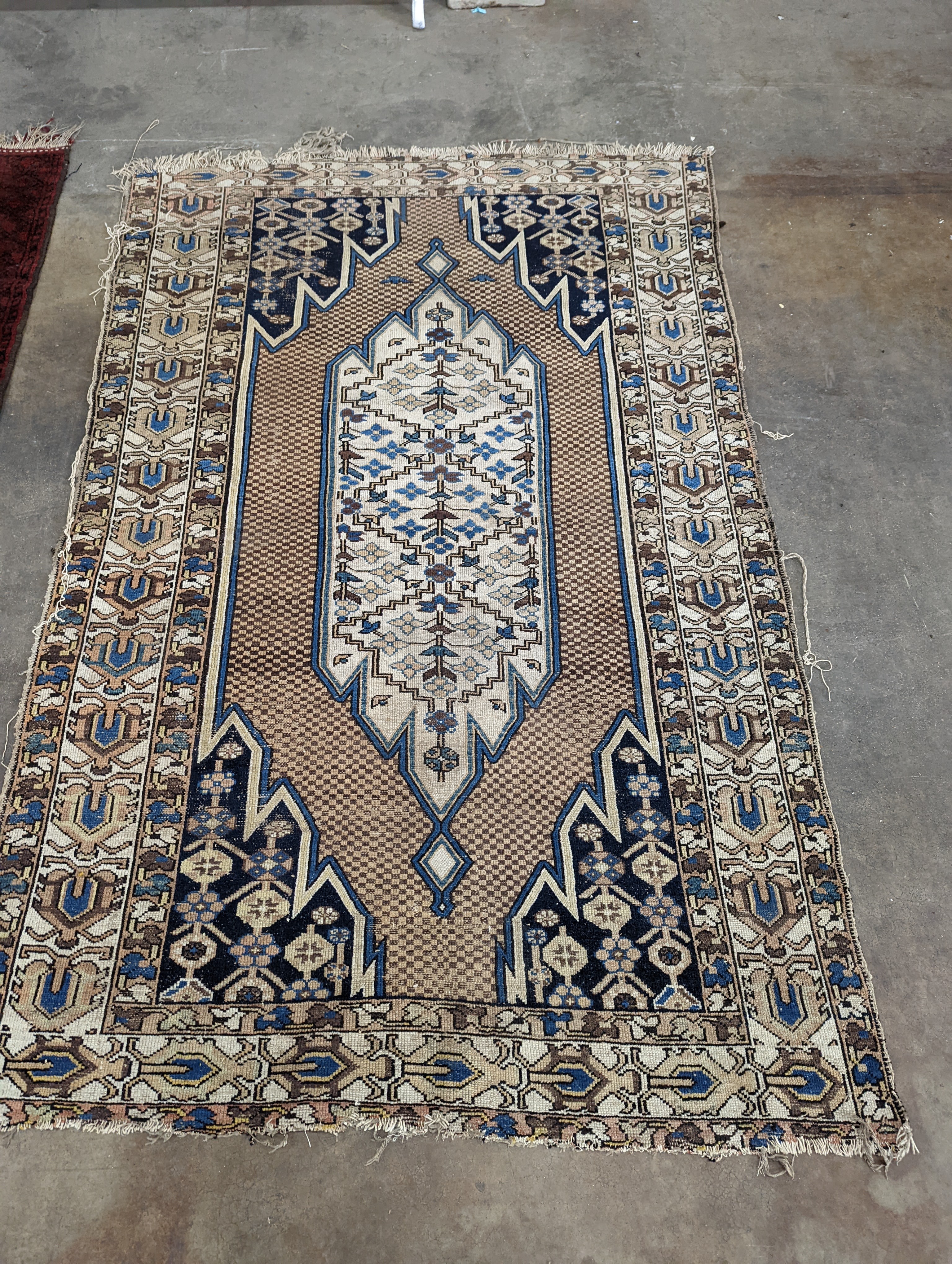 A Soumak rug, the fawn field with chevron borders, 196 x 126cm